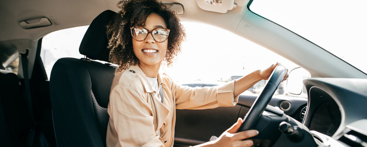 Young woman professional woman driving a car to work