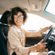 Young woman professional woman driving a car to work