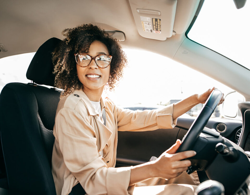 Young woman professional woman driving a car to work